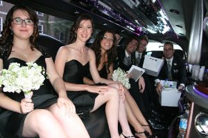 bridesmaid and grooms men on wedding limo service