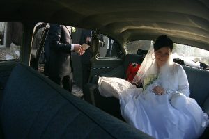 a beautiful bride on her wedding dress with a beautiful smile on her wedding limo service