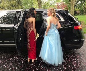 two beautiful ladies wearing a gown riding on their wedding limo service in chicago