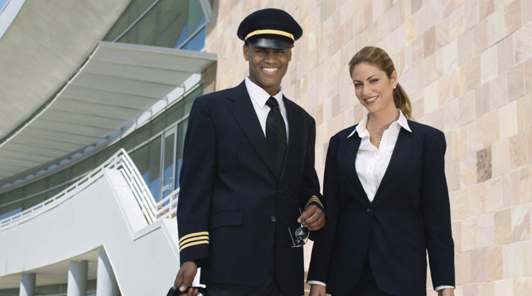 a happy face of a pilot and stewardess waiting for limo