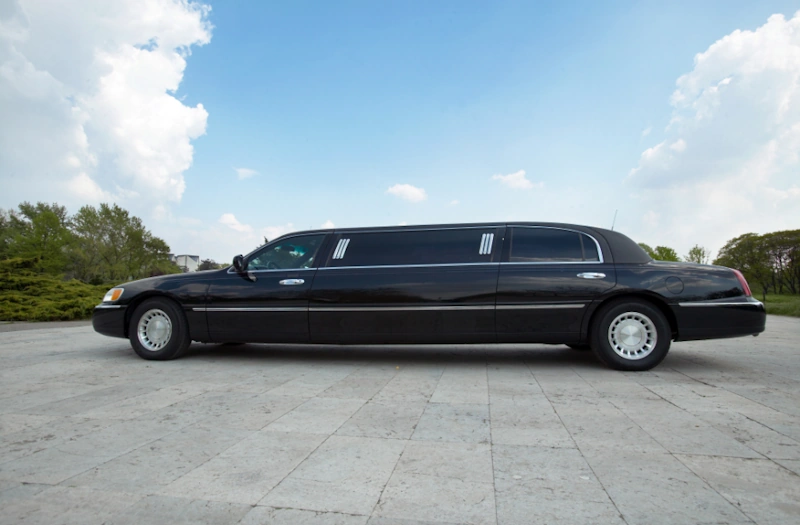 A black limousine parked for Fort Wayne Limo Service