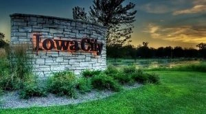 Stone sign saying "Iowa City" for limo service Iowa City